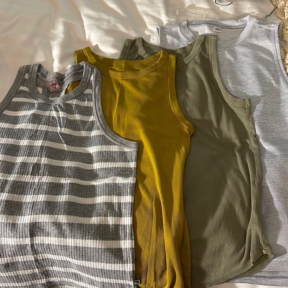 Four tank tops. Mountain hardware, brand new day, Adidas. Fit is M/L